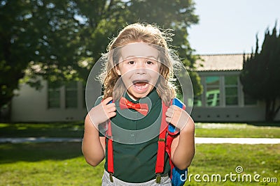 School child concept. Amazed pupil, kid in school uniform with backpack outdoor. Portrait of excited nerd schoolboy. Stock Photo