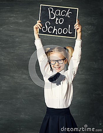 School Child holding Blackboard with Chalk Draw, Back to School, over Black Background, Advertising Girl Stock Photo