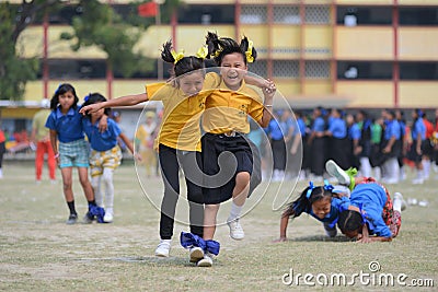 School children compete in three legged race Stock Photo