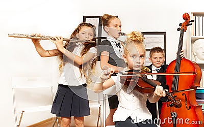 School children play musical instruments together Stock Photo