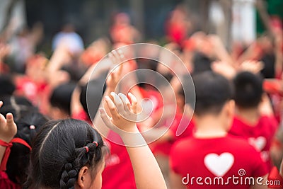 School children raising hands up on celebration day Editorial Stock Photo