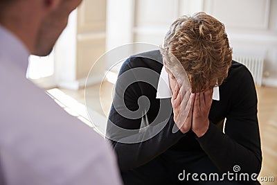 School Counselor Talking To Depressed Male Pupil Stock Photo