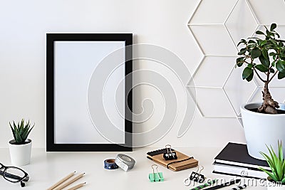 School desk against an empty white wall. Black frame mockup Stock Photo