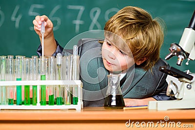 School education. Explore biological molecules. Toddler genius baby. Boy near microscope and test tubes in school Stock Photo