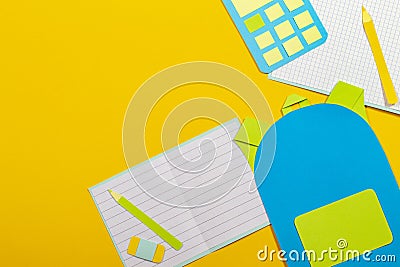 School education papercut background. School bag backpack, notebooks pencils calculator paper cut on yellow background Stock Photo