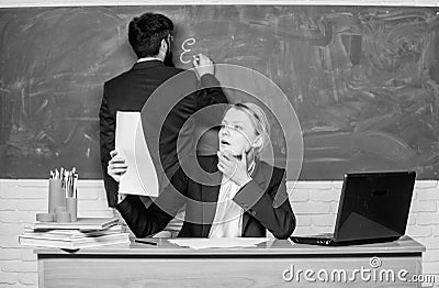 School education. Prepare for school lesson. Check homework. Write down your task. Teachers working in pairs school Stock Photo
