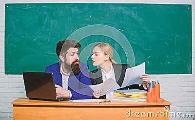 School educator with laptop and principal with documents. Educational program. School education. Prepare for school Stock Photo