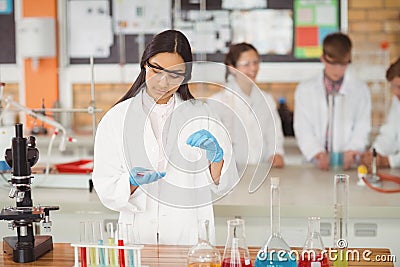 School girl experimenting with chemical in laboratory at school Stock Photo