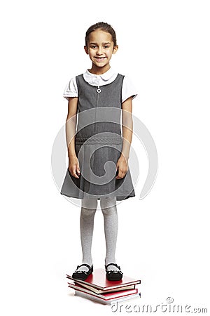 School girl stood on books Stock Photo