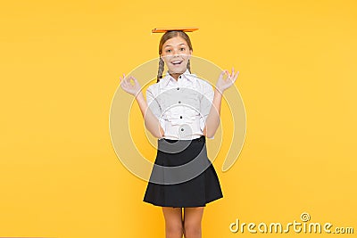 School girl studying textbook. Kid school uniform hold book. Life balance positivity. Dealing with school stress Stock Photo