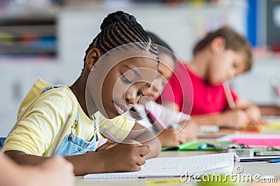 School girl writing in class Stock Photo