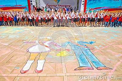 School graduates, written on the pavement, amid a jubilant crowd of graduates Editorial Stock Photo