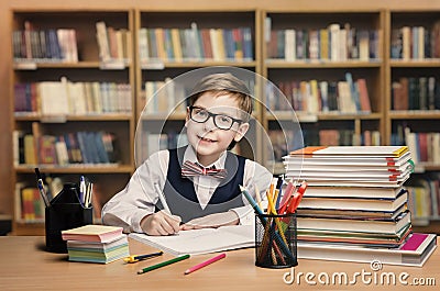 School Kid Studying in Library, Child Writing Book, Shelves Stock Photo