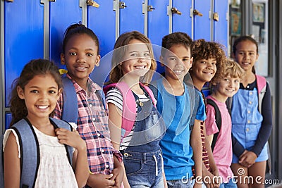 School kids in front of lockers in elementary school hallway Stock Photo