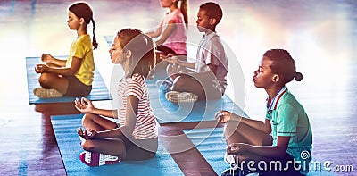 School kids meditating during yoga class Stock Photo