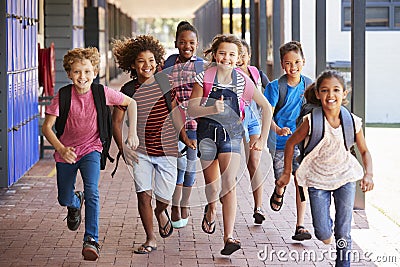 School kids running in elementary school hallway, front view Stock Photo