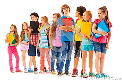 School kids standing in the line with books Stock Photo