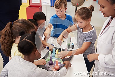 School kids taking part in experiment at science centre Stock Photo