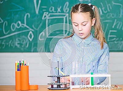 School laboratory. Girl smart student conduct school experiment. School pupil study chemical liquids. School chemistry Stock Photo