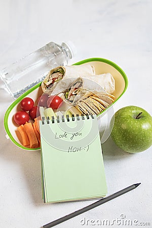 School lunch box with sandwich, vegetables, water, fruits Healthy eating habits concept - background layout with free text space. Stock Photo