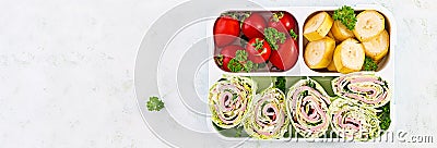 Healthy lunch box with tortilla wraps, tomatoes, banana. Stock Photo