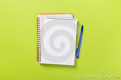 School notebook on a green background, spiral notepad on a table Stock Photo