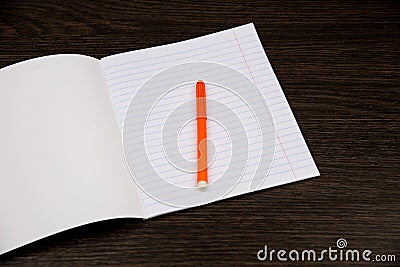 School notebook paper. orange markers. Notebook in line and pencil. open notebook on a brown background. planning. stationery Stock Photo