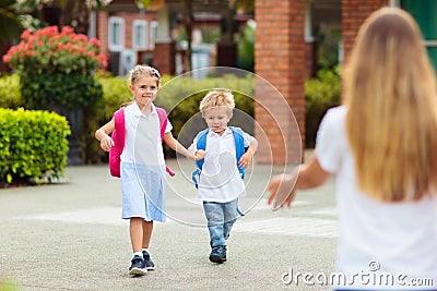 School pick up. Mother and kids after school Stock Photo