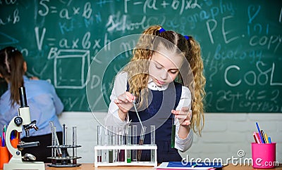 School pupil study chemical liquids. School chemistry lesson. Test tubes with substances. Future microbiologist Stock Photo