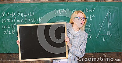 School schedule and extra classes. Teacher woman hold blackboard blank advertisement copy space. School information for Stock Photo