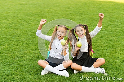 School students girls eating apples for lunch, child care concept Stock Photo