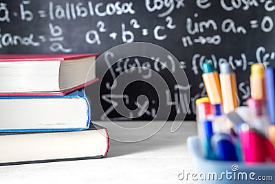 School supplies in classroom. Blackboard or chalkboard in class. Stock Photo