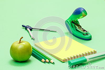 School supplies. Compass, color pencils, notebook, apple and stapler Stock Photo