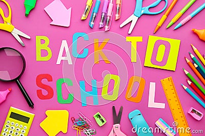 School supplies with inscription back to school on pink concrete background Stock Photo