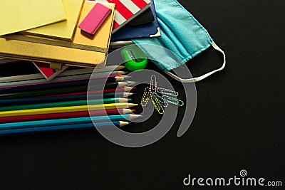 School supplies and medical mask, school opening, return to school after COVID-19 pandemic, new normal concept. Copy space. Stock Photo