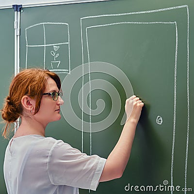 A school teacher is knocking on a chalk painted door. Concept welcome back to school Stock Photo