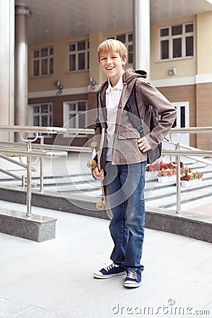 School teen with schoolbag and skateboard Stock Photo