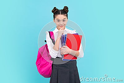 School teenager child girl with book and copybook. Teenager student, blue background. Learning and knowledge Stock Photo