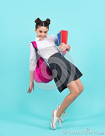 School teenager child girl with book and copybook. Teenager student, blue background. Learning and knowledge Stock Photo
