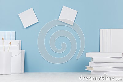 School template - white books, stationery, blank stickers on white desk and soft blue background. Stock Photo