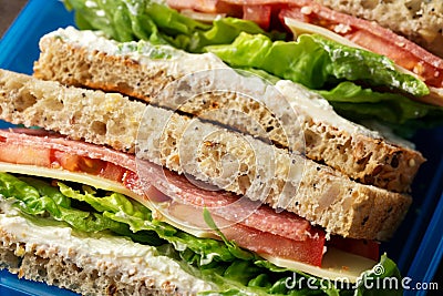 School or work, Lunch box with sandwiches with lettuce, tomatoes, cheese and salami. healthy food. Stock Photo