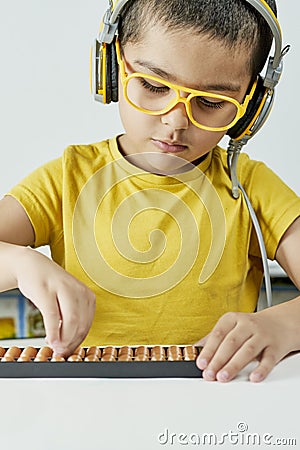 Schoolboy with abacus. Young kid training mental arithmetic Stock Photo