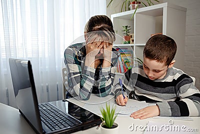 Schoolboy doing school homework. Homeschooling and freelance job Stock Photo