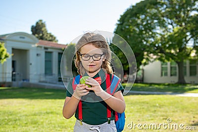 Schoolboy eating tasty aplle lunch outdoors school. Stock Photo