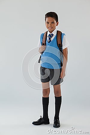 Schoolboy in school uniform with school bag on white background Stock Photo