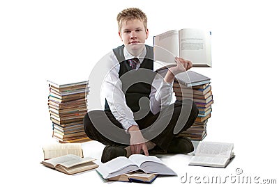 The schoolboy in a school uniform sits on a floor Stock Photo