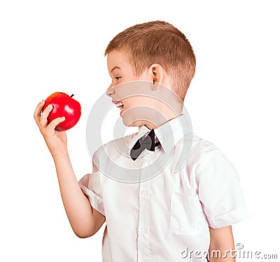 Schoolboy in shirt with butterfly wants to eat an Apple, isolated on white Stock Photo