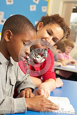 Schoolboy Studying In Classroom Stock Photo