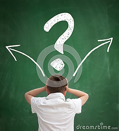 Schoolboy thinking with question marks overhead Stock Photo