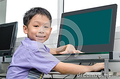 Schoolboy using computer Stock Photo